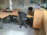 a desk with a chair and a computer on it