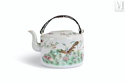 a tea pot with a bird on it on a white surface