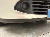 a close up of a car ' s front bumper with a license plate on it