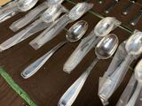 many spoons and spoon spoons laid out on a table