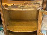 a wooden cabinet with a glass door on it