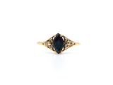 a close up of a ring with a blue stone in it