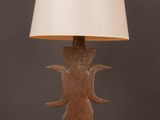 a close up of a lamp on a wooden table with a lamp shade on it