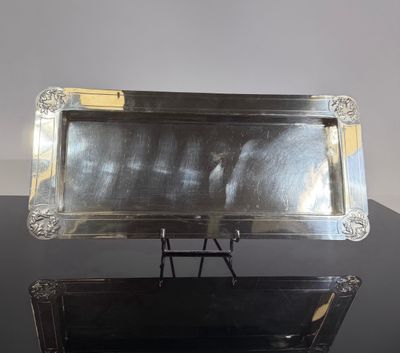 two silver trays sitting on top of a black table