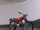 a red motorcycle parked in a parking garage