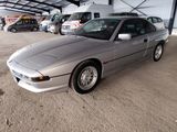 a silver car that is parked in a garage
