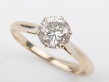 a gold engagement ring with a round brilliant cut diamond