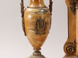 pair of antique vases with handles on pedestals on a white background