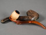 a pipe and a pipe holder sitting on a table