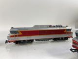 two toy trains that are sitting on a white surface