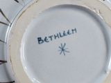 a person holding a plate with the word berlin written on it