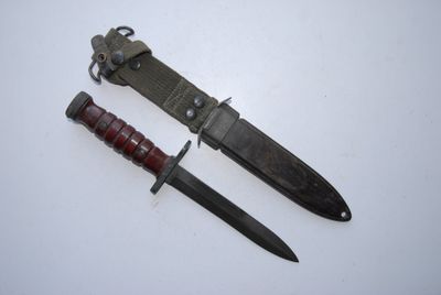 two knives are laying next to each other on a white surface