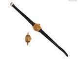 une image représentant une montre en or et un bracelet en cuir noir