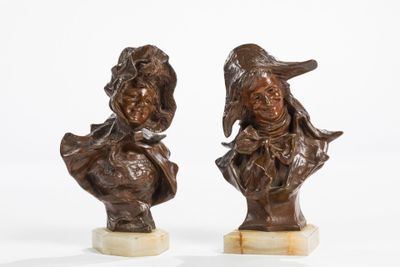 pair of bronze busts of a man and a woman on marble bases