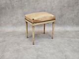 an antique stool with a woven seat on a grey background