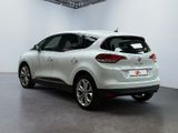 the rear end of a white car in a white room
