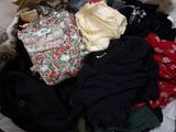 a basket full of clothes that is sitting on the floor