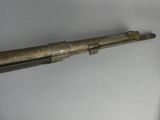 an old gun that is on display on a table