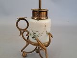 a white and gold vase with a handle on a table