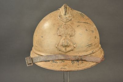 an old fireman ' s helmet on a metal stand on a gray background