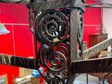 a metal sculpture of a bird hanging from the ceiling