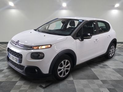 the white citrole is parked on a checkered tile floor