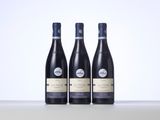 three bottles of wine sitting on top of a table
