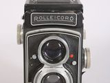 a close up of an old fashioned camera on a white surface