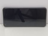 the back of a black cell phone sitting on top of a white table