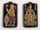 pair of ceramic plaques depicting a man and a woman holding fish