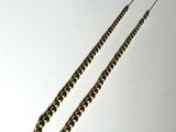 a necklace that is laying on a white surface