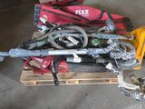 a pile of tools sitting on a pallet in a garage