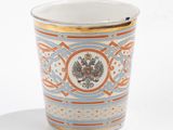 a cup with a design on it sitting on a table