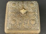 an image of a gold box with a cross on it