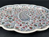 a close up of a plate with a paisley design on it