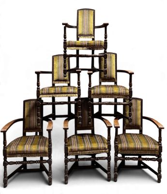 several chairs are stacked on top of each other on a white surface