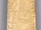 an old book sitting on top of a gray surface