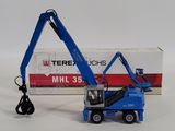 a blue crane that is sitting next to a box
