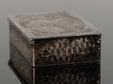 a silver box sitting on top of a black table