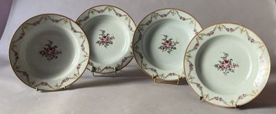 three plates with floral designs are sitting on a white surface