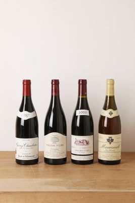 quatre bouteilles de vin sont alignées sur une table en bois