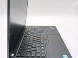 a laptop that is open on a white surface