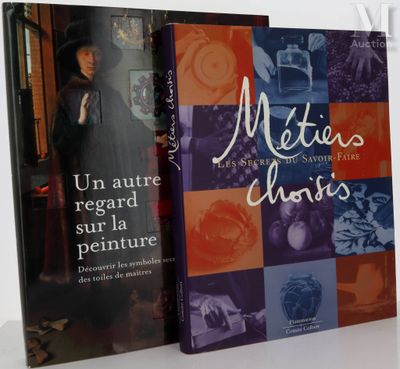 two books on a white table with a picture of a woman in a black dress