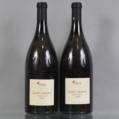 two bottles of wine sitting on top of a table next to each other