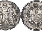a silver coin with an image of a woman and a man on it