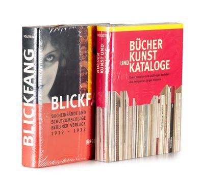 two books sitting on top of each other on a white surface