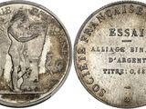 a silver coin with a man holding a sword on top of it