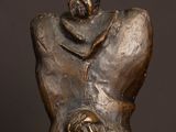 bronze statue of a man holding a baby in his arms