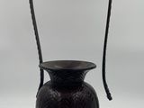 an image of a black vase with a handle on a white background