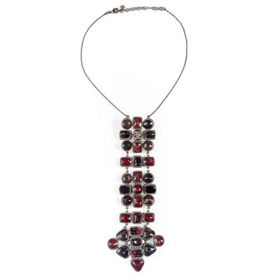 a close up of a necklace on a white background